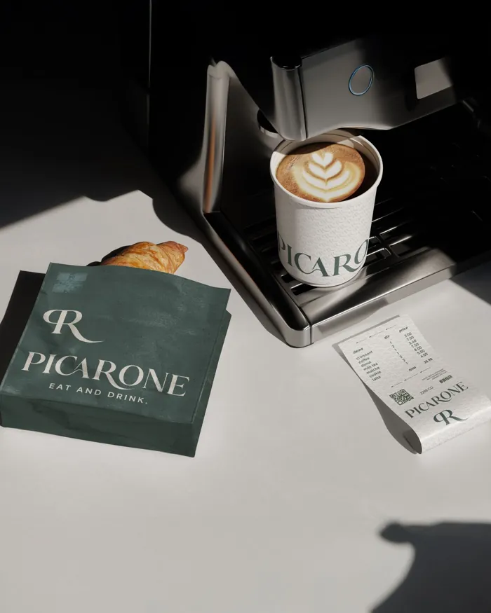 Picarone café branding on a paper bag, a coffee cup and a receipt